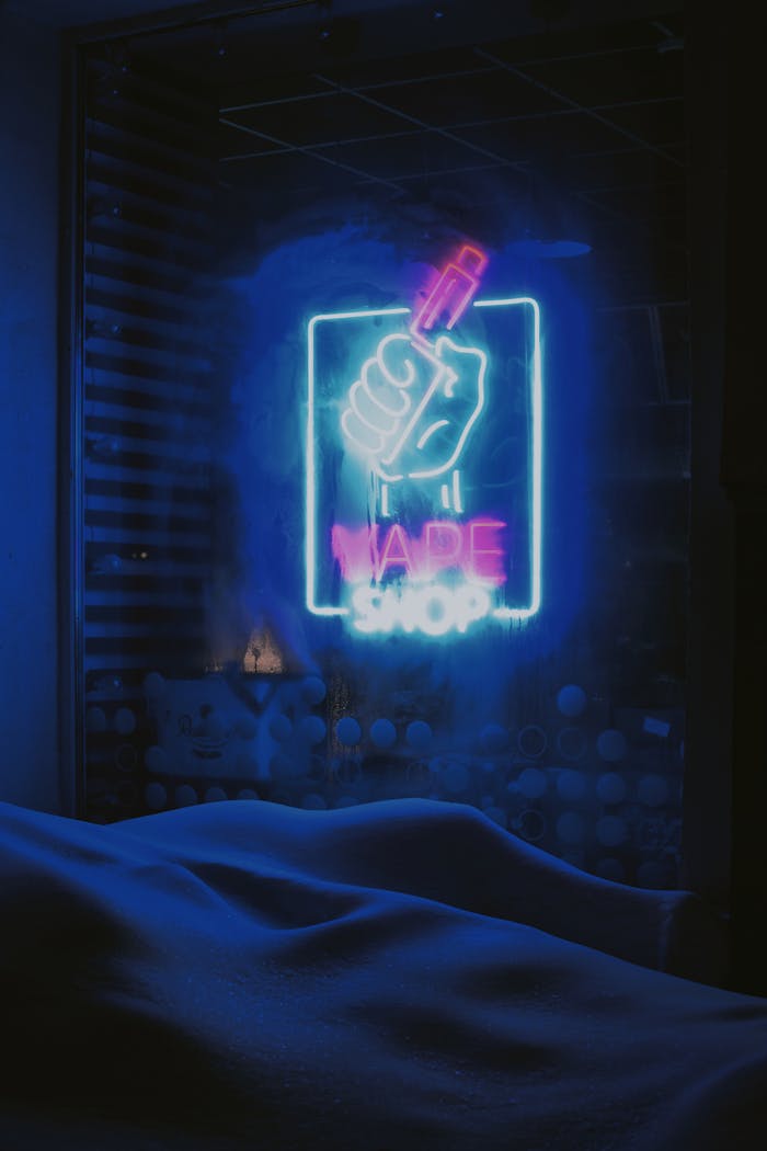 Eye-catching neon sign of a vape shop glowing brightly at night.